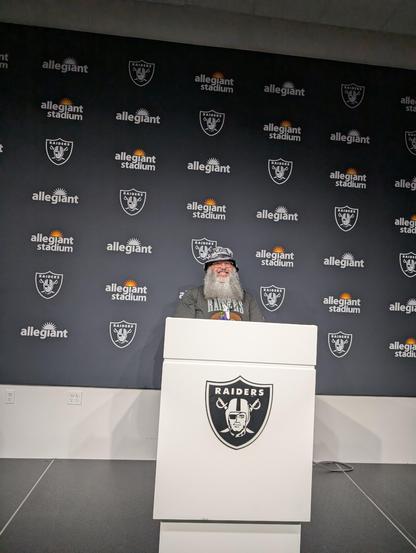 Standing behind the media podium