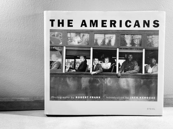 A black-and-white photo I took of my copy of “the Americans“ which is a collection of photographs by one of my favorite photographers, Robert Frank. The photos are pre segregation, and the cover photo is the side of a bus where Black people are in the back and white in front. It’s an outsiders perspective on 1950s America. Robert is European.