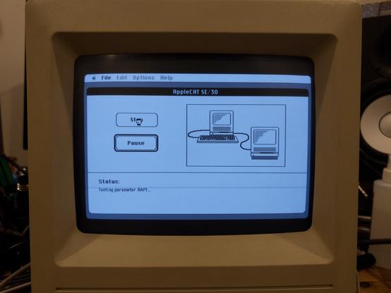 The screen of a working Macintosh SE/30 displaying an application called AppleCAT, which is running diagnostics on another (dead) SE/30 via a printer cable