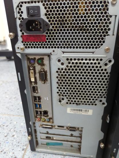 The dusty back of one of the computers