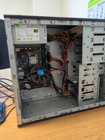 Inside another computer; the CPU cooler is hanging by its 4-PIN cable