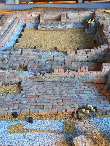 Zoomed in.You can make out a fireplace, and there's a small area where either bricks paved the floor or a wall has collapsed.