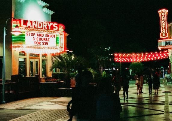 A view of a small section of "Broadway At The Beach" in Myrtle Beach, South Carolina.  The red string lights in the photo are actually white and not red.  The red glow is the result of the type of film I used.