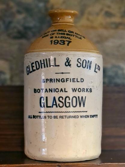 A stoneware flagon woth the inscription: Gledhill & Son Ltd. Springfield Botanical Works Glasgow. All bottles should be returned when empty.