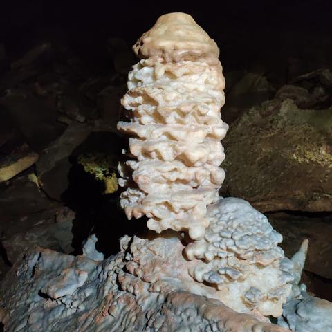 A stalagmite with lots of layers looking a bit like a stack of pancakes