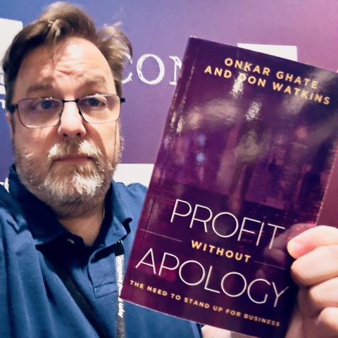 selfie holding the book “Profit Without Apology"