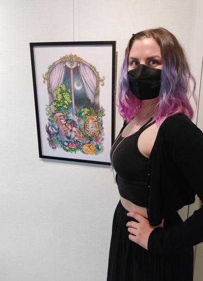 The artist (me) posing in front of the original painting in an art gallery