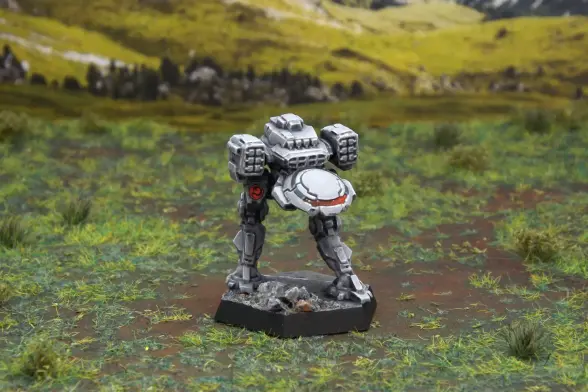 A painted miniature of a Jenner IIC 'Mech.  It is light ash gray, and the cockpit glass is dark red.  The dragon emblem of the Draconis Combine is on its right leg.  A thin black stripe traces the circumference of its saucer-shaped head.  The miniature is photographed on grassy terrain.