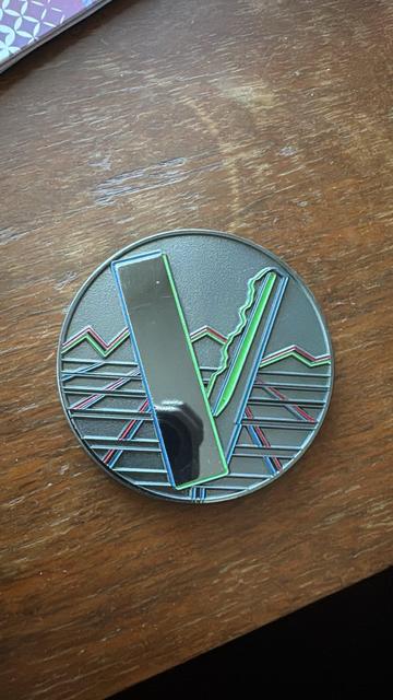 the flipside of the coin, featuring the VEilid logo.