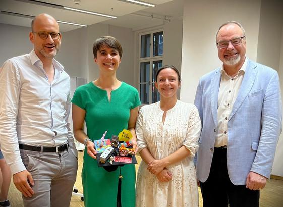 Group picture, from left to right: Fabian Waldinger, Ann-Christin Kreyer (holding her doctor's hat), Hanna Hottenrott, and Dietmar Harhoff.