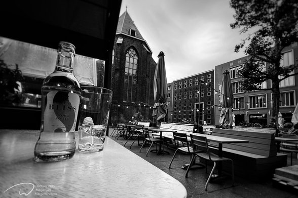 Altering Air - After days of extreme heat due to a heatwave, we are waiting for the thunderstorms and lightning coming in. Sitting at a covered table on an almost empty terrace overlooking the city's old buildings and a threatening sky above.