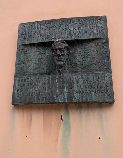 A metal memorial plate on a wall