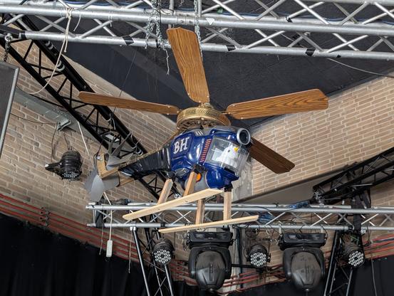 A helicopter made from a vacuum, ceiling fan and other bits operated by a unicorn.