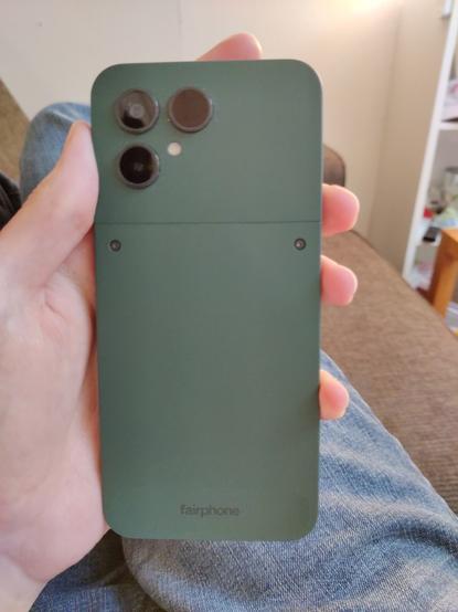 The back of the fairphone android phone. It's forest green.