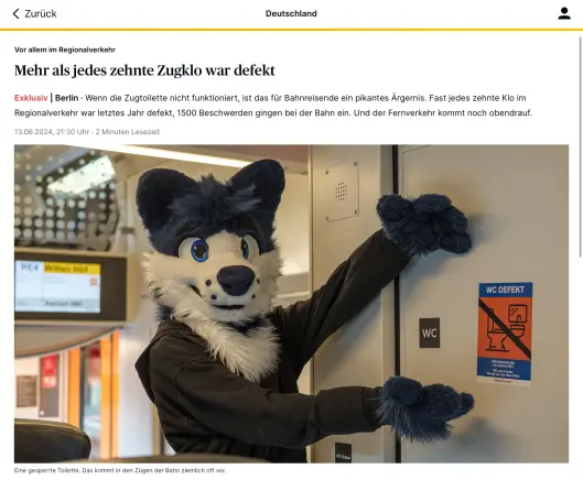 Ein RP Artikel "Mehr als jedes zehnte Zugklo war defekt" mit einem Bild
Bild: Ein Fuchs Fursuiter der auf ein WC Defekt Schild zeigt im RRX