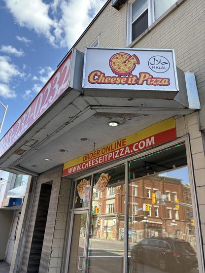 A former pizza joint with papered up windows.