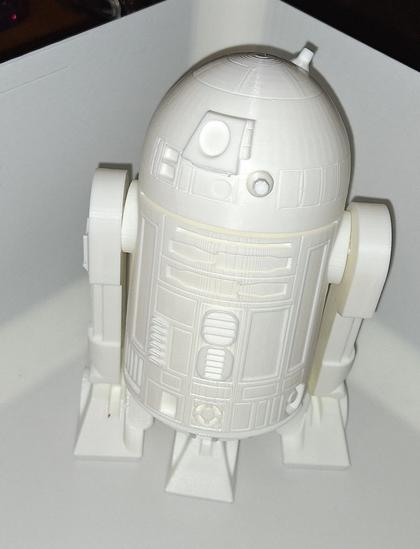 A white 3d printed r2d2 against a white background