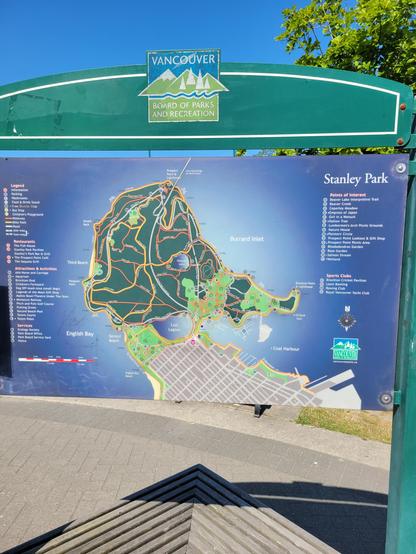 A map of Stanley Park. Lots of paths are spread over the map. Orange is for walking and yellow for bikes. Both orange and yellow are on the perimeter of the park along the seawall. It's about 17 miles.