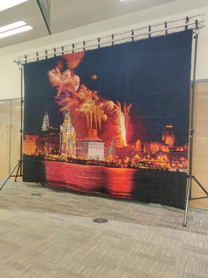 A huge hand-latched rug featuring a view of the Liverpool waterfront with fireworks