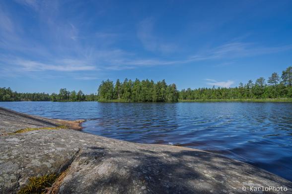A lake, with cliffs in the foreground.