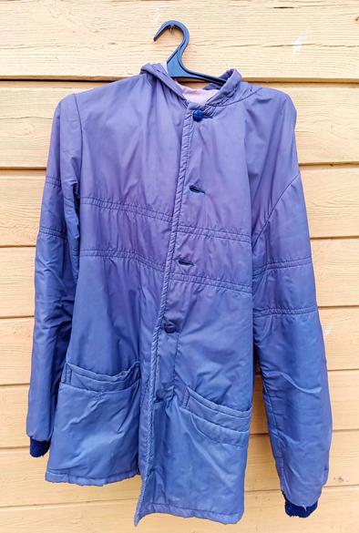 A purple synthetic coat with smooth finish and hood. It's been patched at a pocket and has a few holes. Would make an ok work jacket for someone.