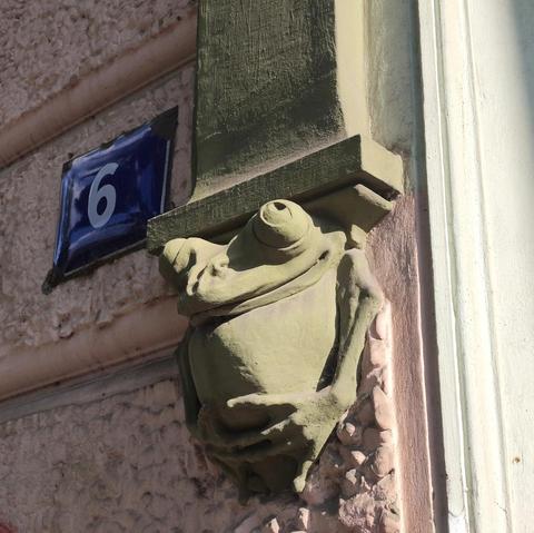Green frog corbel on the facade