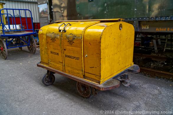 A photo of a german postal service car used to store mail to load into or unload from railway mail cars.