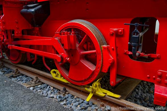A detail photo of a wheel of a steam locomotive.