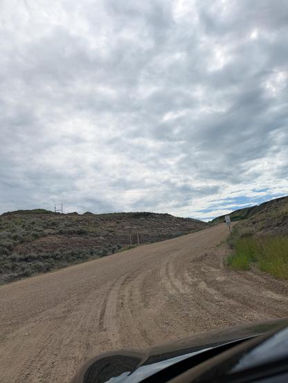 dirt road climbing up a hill