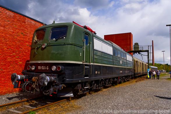 A photo of a green electric locomotive with the number 151 001-5.