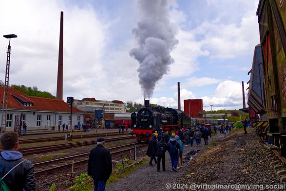 A photo of a steam locomotive, the P1 with the number 38 2267, steam is coming from the chimney. Starting to drive.