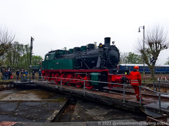 A photo of a green and black steam locomotive with the number 41-E on the turntable.