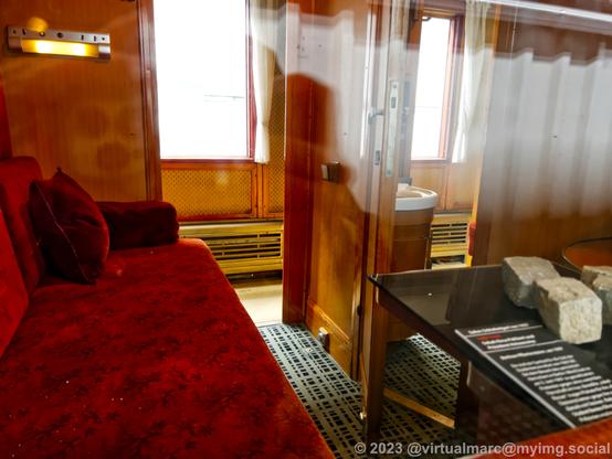 A photo of the inside of a sleeping car through a window.