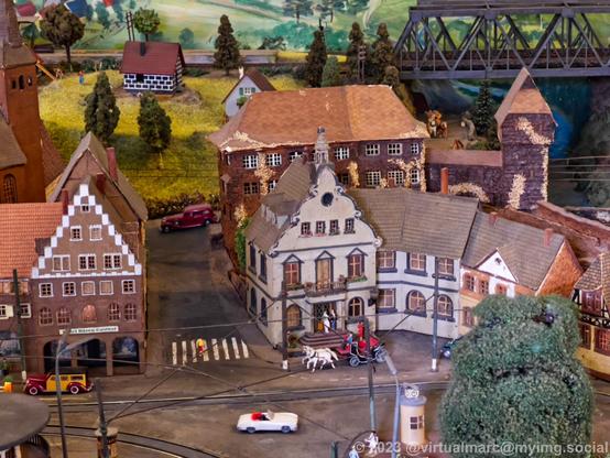 A detail photo of a model railway of a city with old houses.