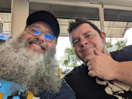 Two big men taking a selfie at a restaurant