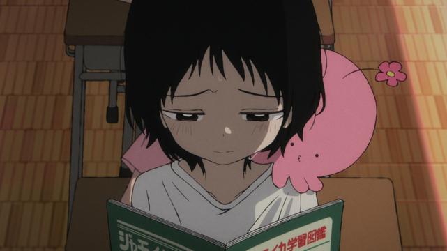 Screenshot from “Takopi’s Original Sin” Episode 2

Shizuka, a young girl wearing a plain white t-shirt and a sad expression, stands at her schooldesk looking at her textbook. On her shoulder is Takopi, who resembles a pink, stubby-armed octopus with a flower protruding from its head.