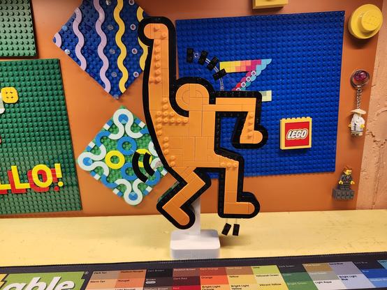 a model of a dancing figure made of Lego bricks