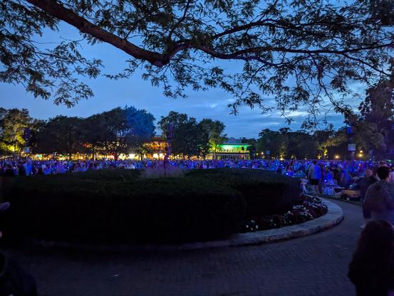 A view of the crowds behind us with all of their wristbands the same color of blue with the blue/gray sunset in the background.