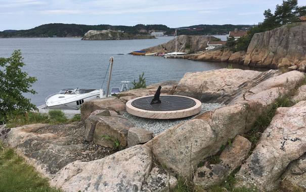 Sundial of bronze with natural stone.