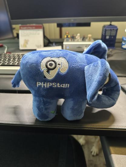 Blue elephant plushie with the PHPStan logo on its side.