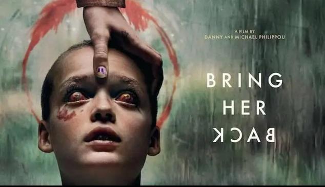 The poster of the film features a 10 year old boy with a shaved head and blood red eyes. A hand is placed on his head. There’s a red circle behind him.