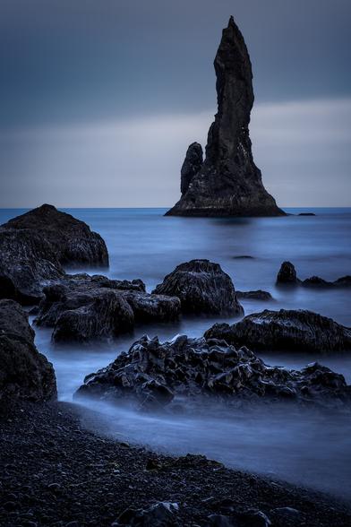 Long exposure view of the dramatic Reynisdrangar (basalt sea stacks) situated under the mountain Reynisfjall near the village of Vík í Mýrdal on the southern coast of Iceland.