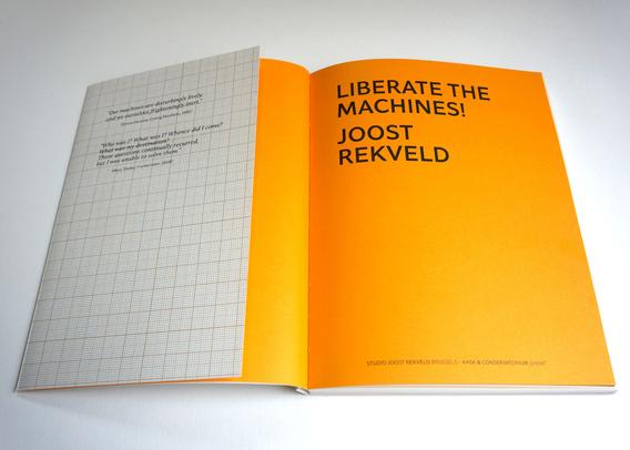 A book opened on its deep ochre/orange first page, which says: "Liberate the Machines!, Joost Rekveld".