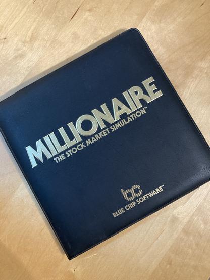 The cover of Millionaire: The Stock Market Simulation by Blue Chip Software. It is a vinyl executive folio case, unusual for a computer game.