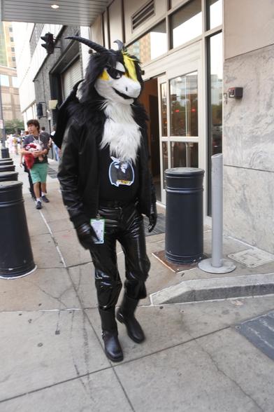 Terry the dragon in a Pittsburgh street after the dragon meet.  He is wearing PVC jeans in broad daylight which would result in a lot of pearl-clutching if he tried that at Confuzzled