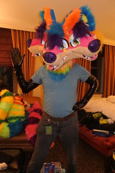 Fursuit photo.  Merlin let me try out Sherbet the Cerberus, while wearing shoulder-length PVC gloves to hide the skin.
Sherbet is a three-headed rainbow sparkledog 

Photo by Merlin