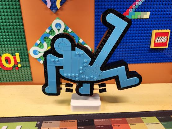 a model of a dancing figure made of Lego bricks