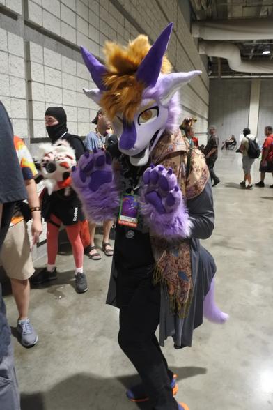 Fursuit photo - Chipazui the purple dragon near the registration queue for Anthrocon 2025