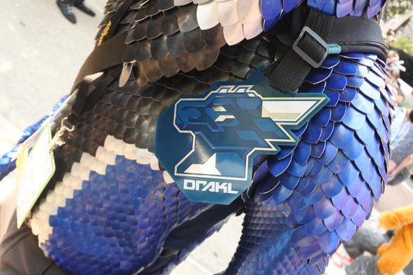 Closeup of Drakl's top, showing a robotic-looking badge that glows when powered up.  This also gives a good view of the scalework on his arms and chest.