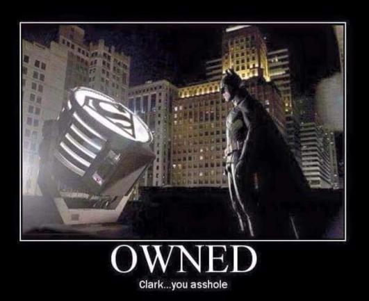 Meme showing Batman standing next to a large light projector and staring at it. But instead of the usual Batman logo on the lamp (for making the Bat-Signal), there is an "S" logo from Superman's costume. 

Meme text reads, 
"OWNED! 
Clark... You asshole."